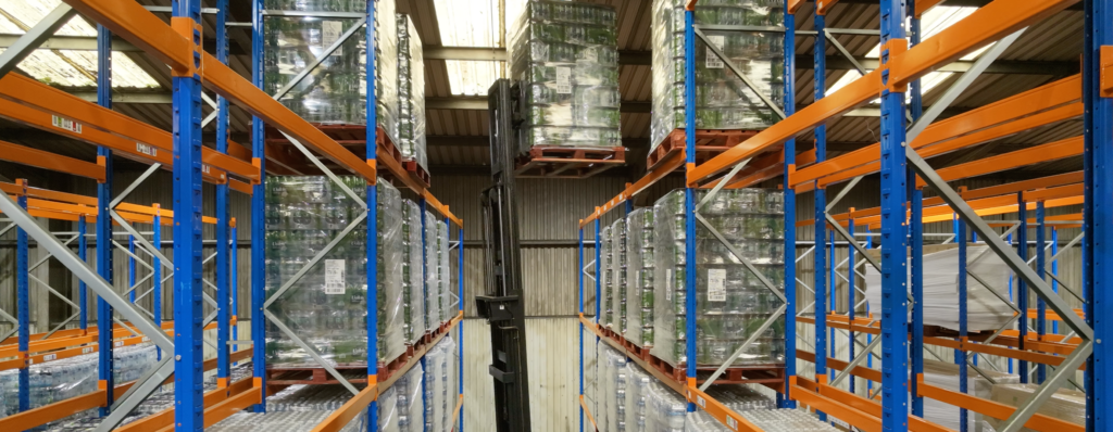 Ayla Group warehouse interior showing an aisle of high-bay pallet racking used for fulfilment and storage