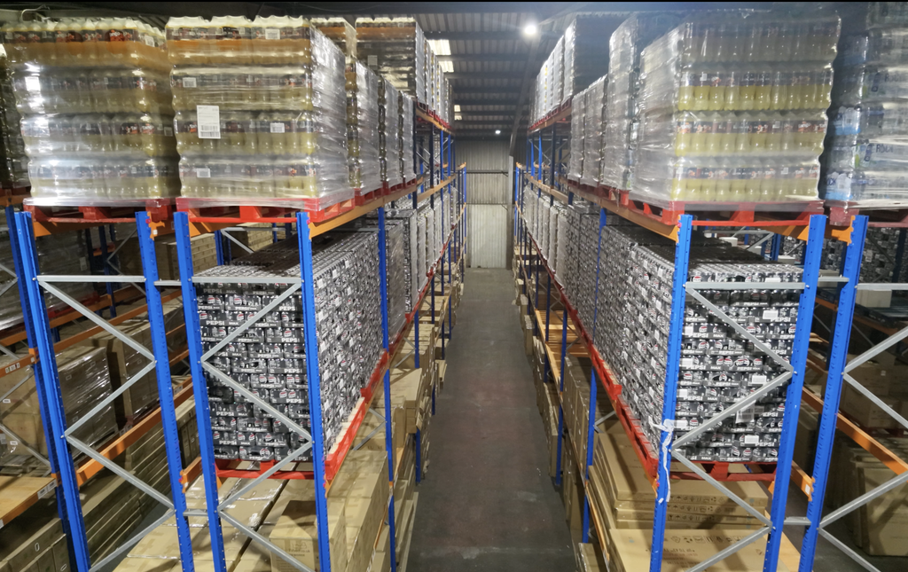 Towering high-bay pallet racking filled with inventory in Ayla Group's UK fulfilment and distribution centre